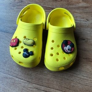 Yellow crocs with Disney accessories